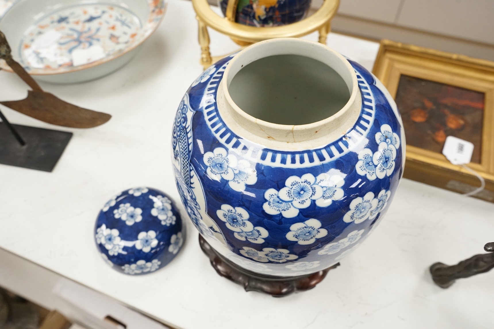 A 19th century Chinese blue and white jar and cover, on hardwood stand, 34cm high